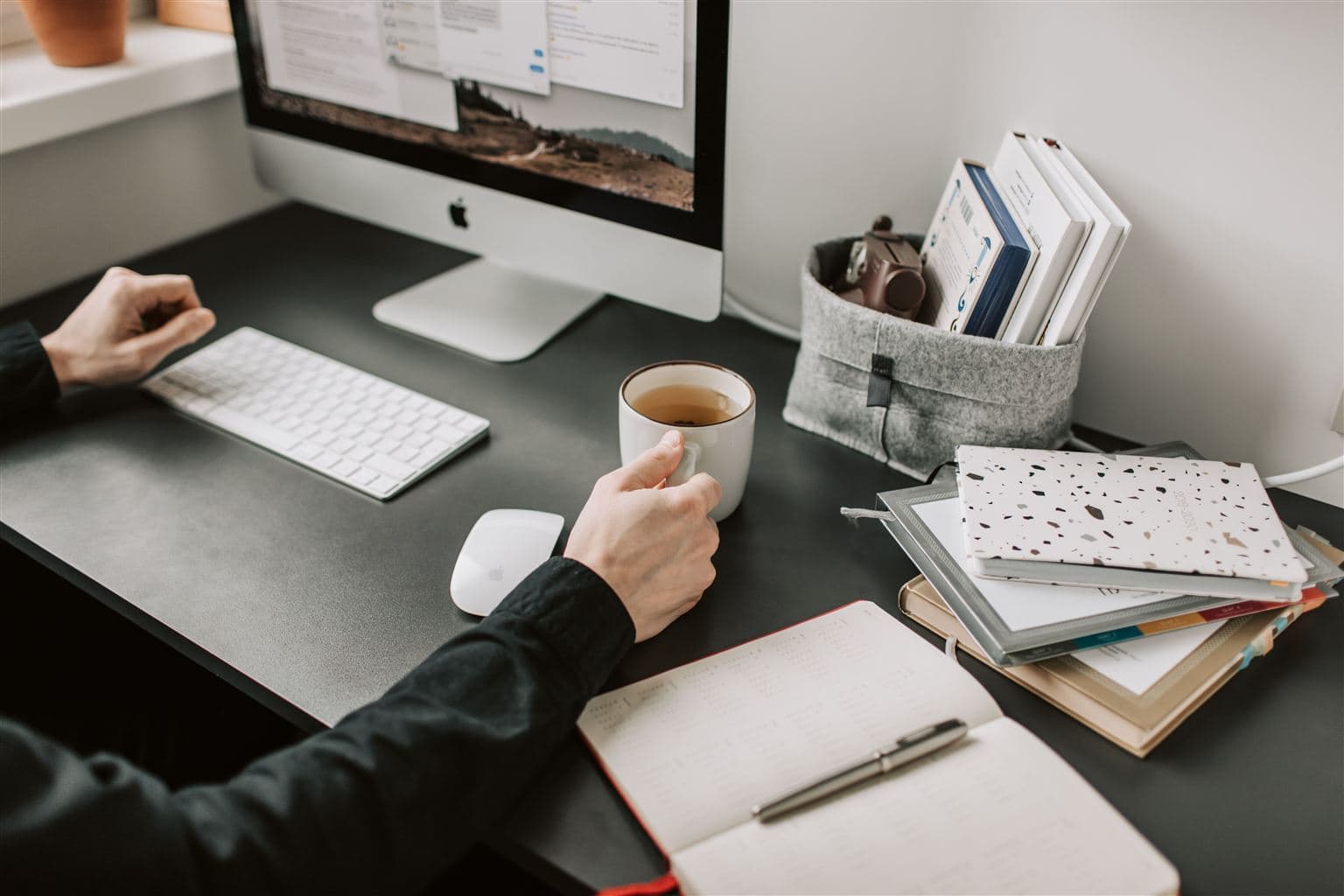 Workspace with computer, coffee and notebook
